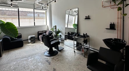 Modern salon setup at Cammarata Studio in London, England, GB with stylish seating and decor.