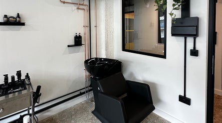 Modern salon wash station at Cammarata Studio, London, England, GB, showcasing sleek design and styling products.