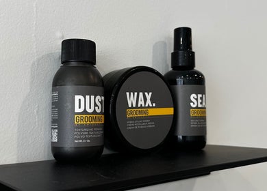 Cammarata Studio London showcases grooming products on a sleek shelf for a chic style.