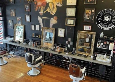 Interior of Jetcharm Barbershop & Gentlemen’s Quarters in New Plymouth, Taranaki Region, NZ with vintage chairs and decor.
