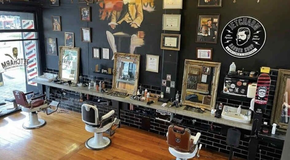 Interior of Jetcharm Barbershop & Gentlemen’s Quarters in New Plymouth, Taranaki Region, NZ with vintage chairs and decor.
