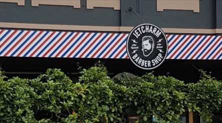 Entrance of Jetcharm Barbershop & Gentlemen’s Quarters in New Plymouth, Taranaki Region, NZ with striped awning.