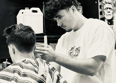 Barber styling a customer's hair at Jetcharm Barbershop & Gentlemen’s Quarters, New Plymouth, Taranaki Region, NZ.