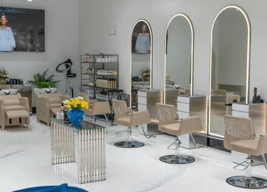 Elegant salon interior at Mustafa Asoglu Hair Design, Delray Beach, Florida, US, featuring modern styling chairs.