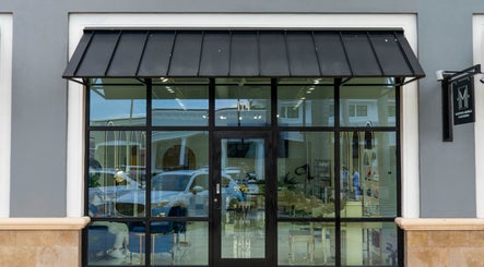 Front view of Mustafa Asoglu Hair Design in Delray Beach, Florida, US, showcasing modern entrance design.
