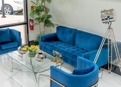 Stylish blue velvet lounge area at Mustafa Asoglu Hair Design, Delray Beach, Florida, US.