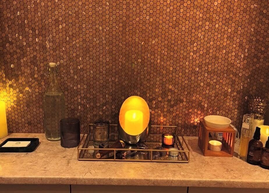 Warm glowing candles in Tula Ayurveda spa setting in Frome, England, GB, creating a calming ambiance.