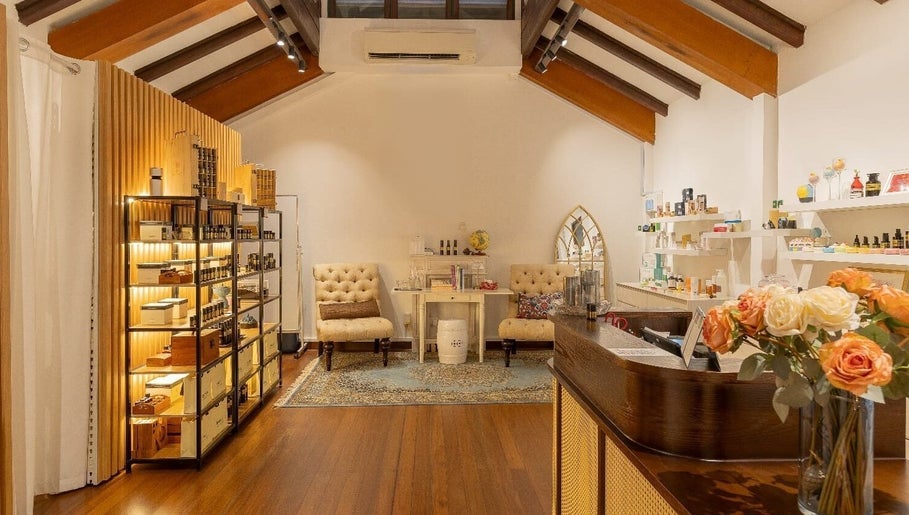 Cozy interior of Roses & More Skin Alchemy featuring plush chairs and wooden shelves, Singapore, Singapore, SG.