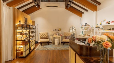 Cozy interior of Roses & More Skin Alchemy featuring plush chairs and wooden shelves, Singapore, Singapore, SG.
