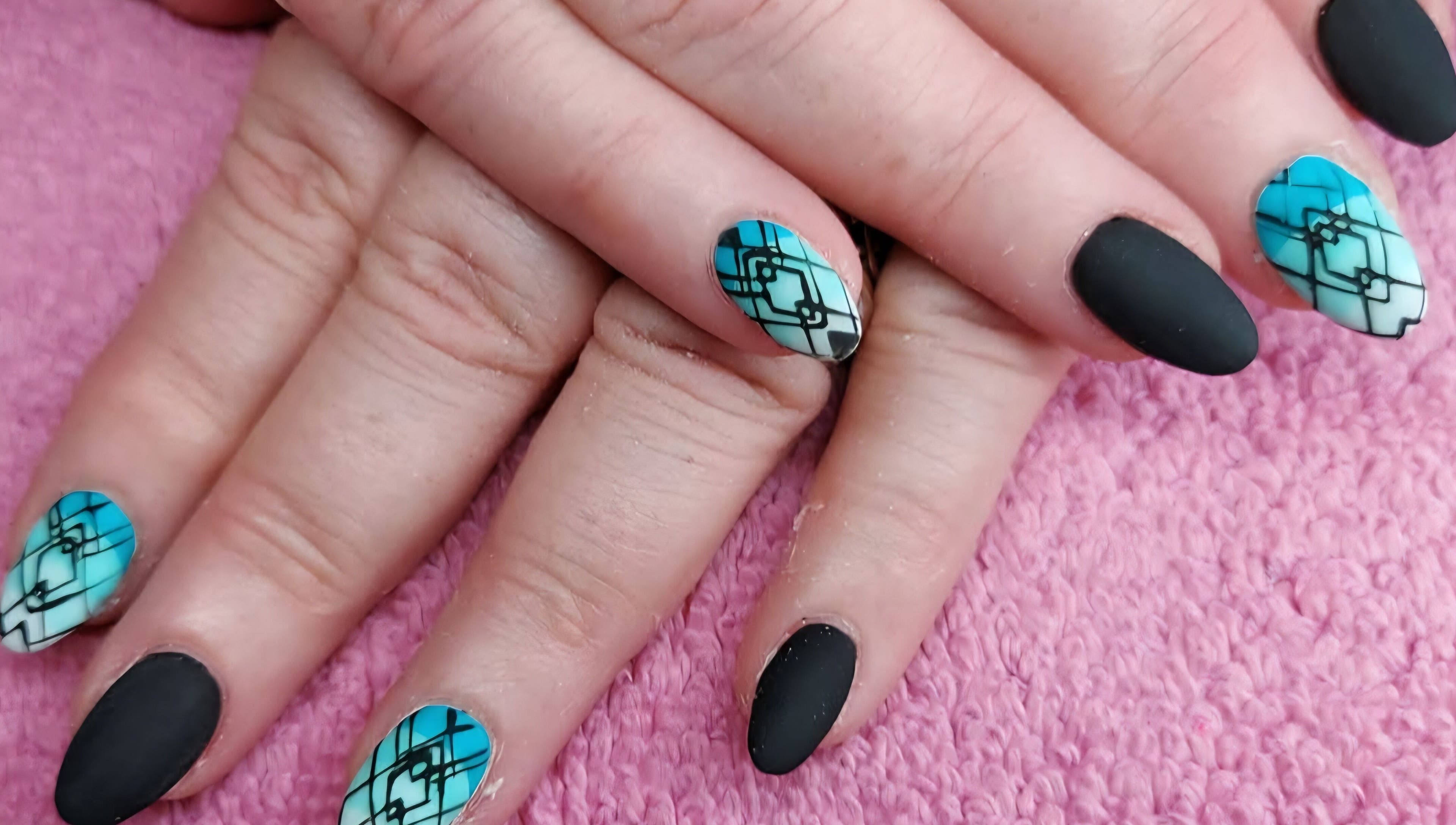 Geometric nail art in blue and black at Elysian Beauty and Piercing, Sudbury, GB.