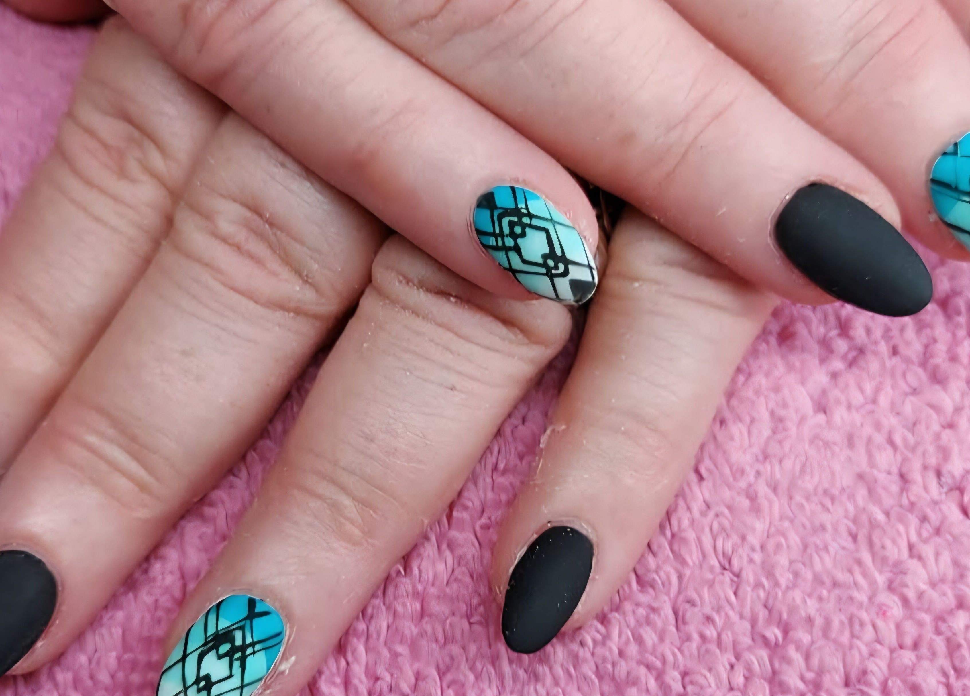 Geometric nail art in blue and black at Elysian Beauty and Piercing, Sudbury, GB.