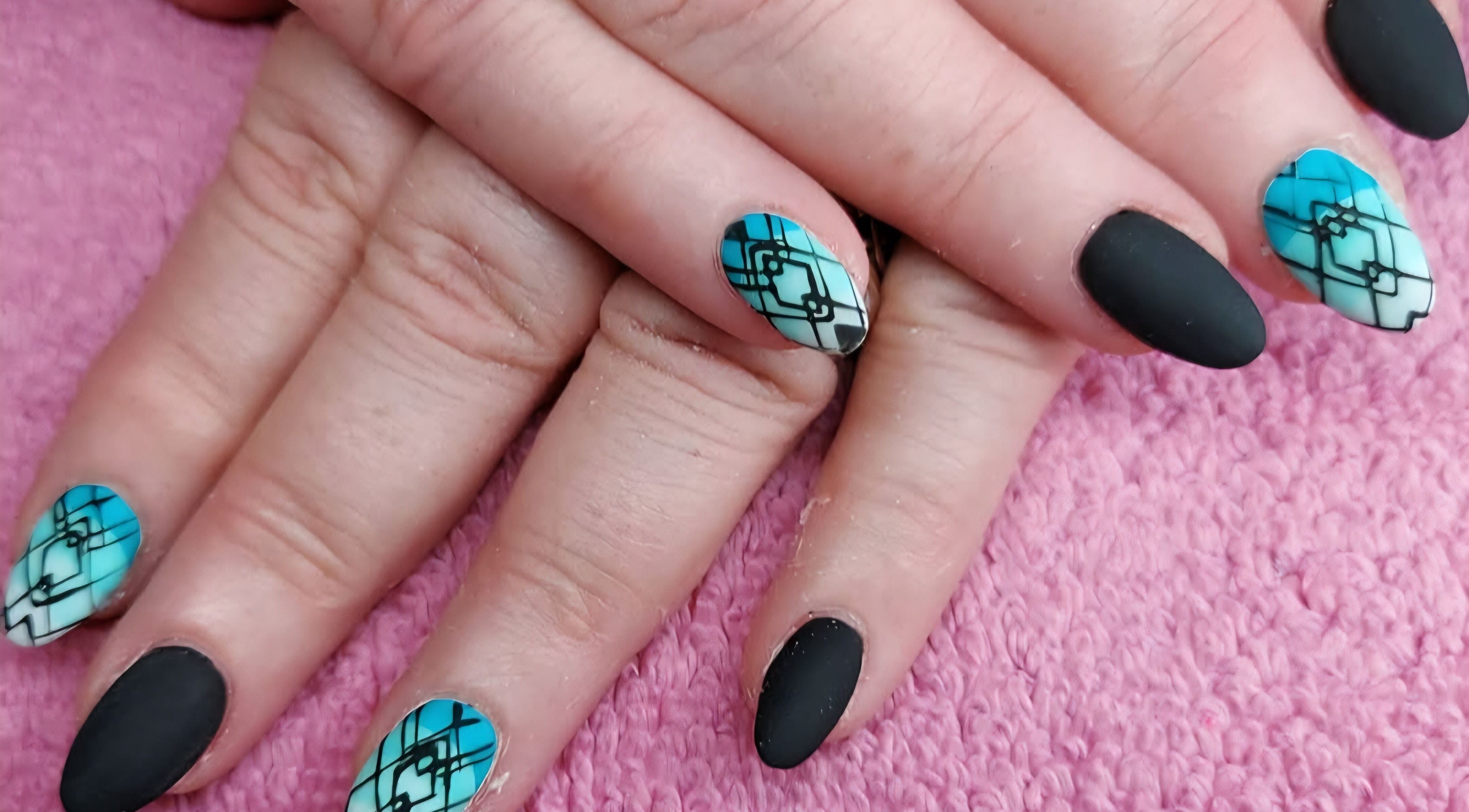 Geometric nail art in blue and black at Elysian Beauty and Piercing, Sudbury, GB.