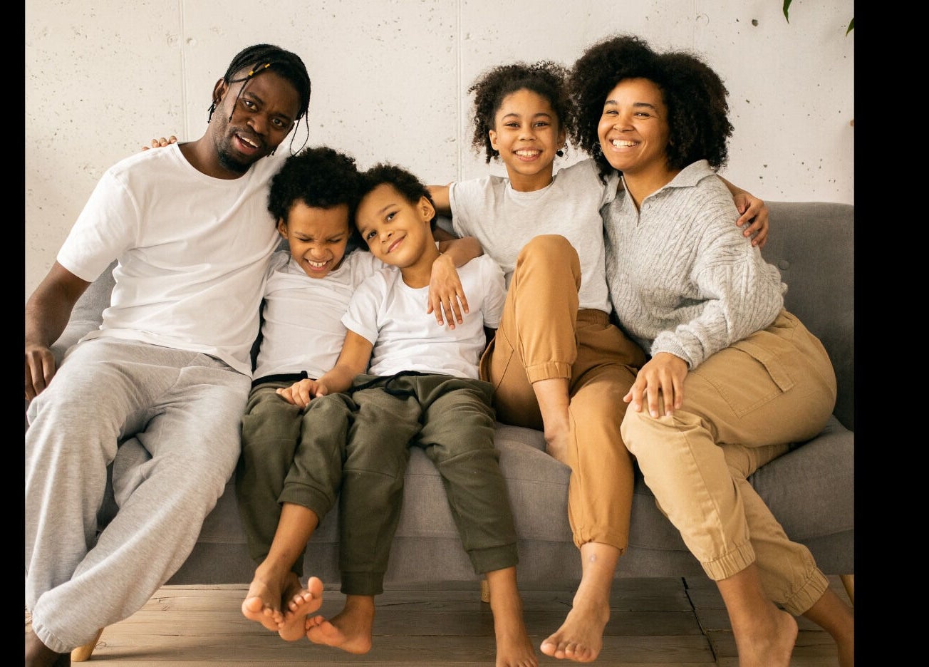 Warm family gathering on a sofa at Mindful Moments Wellness Hub, Johannesburg, ZA.