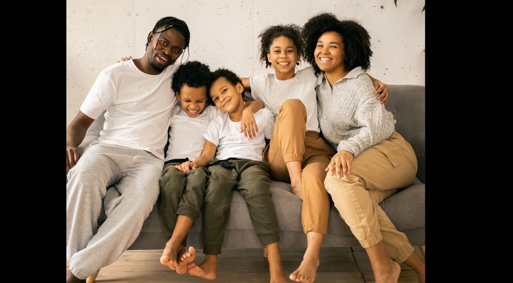 Warm family gathering on a sofa at Mindful Moments Wellness Hub, Johannesburg, ZA.