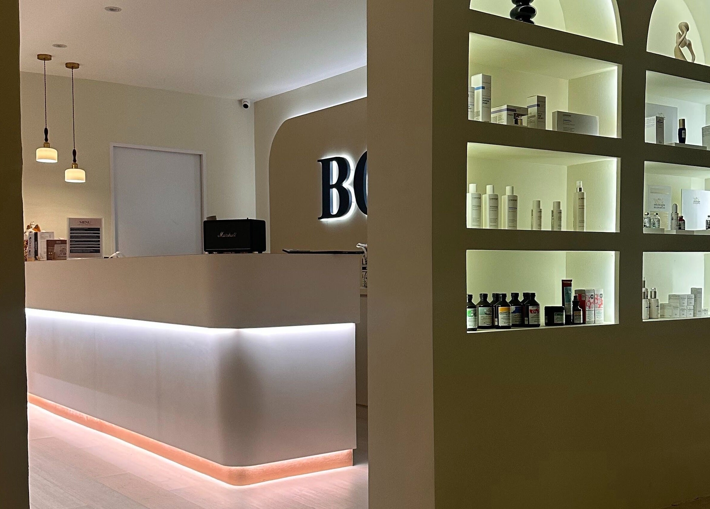 Reception area at Bond Aesthetic, Petaling Jaya, Selangor, MY, showcasing modern decor and product displays.