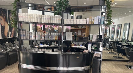 Interior view of Charlotte Miller Hair Design in Marlow, England, GB. A modern salon with sleek black furniture.