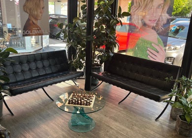 Elegant waiting area at Charlotte Miller Hair Design, Marlow, England, GB with stylish seating and greenery.