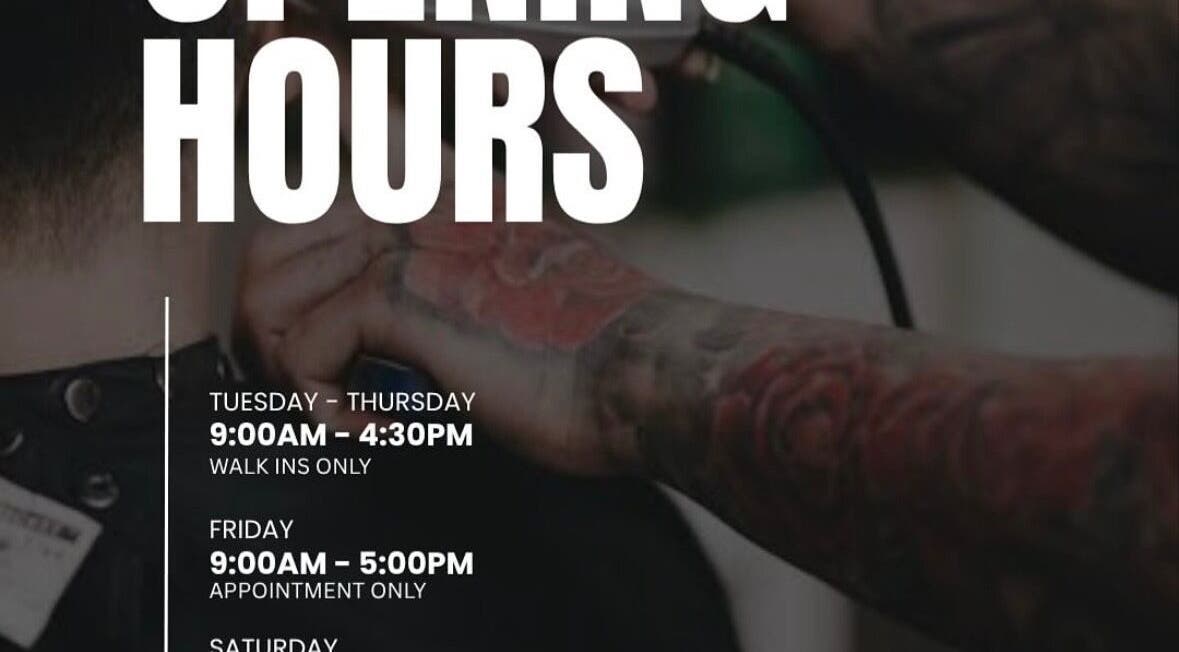 Tattooed barber at Yass_Fadez in Bexley, NSW, showcasing unique opening hours with professional grooming.