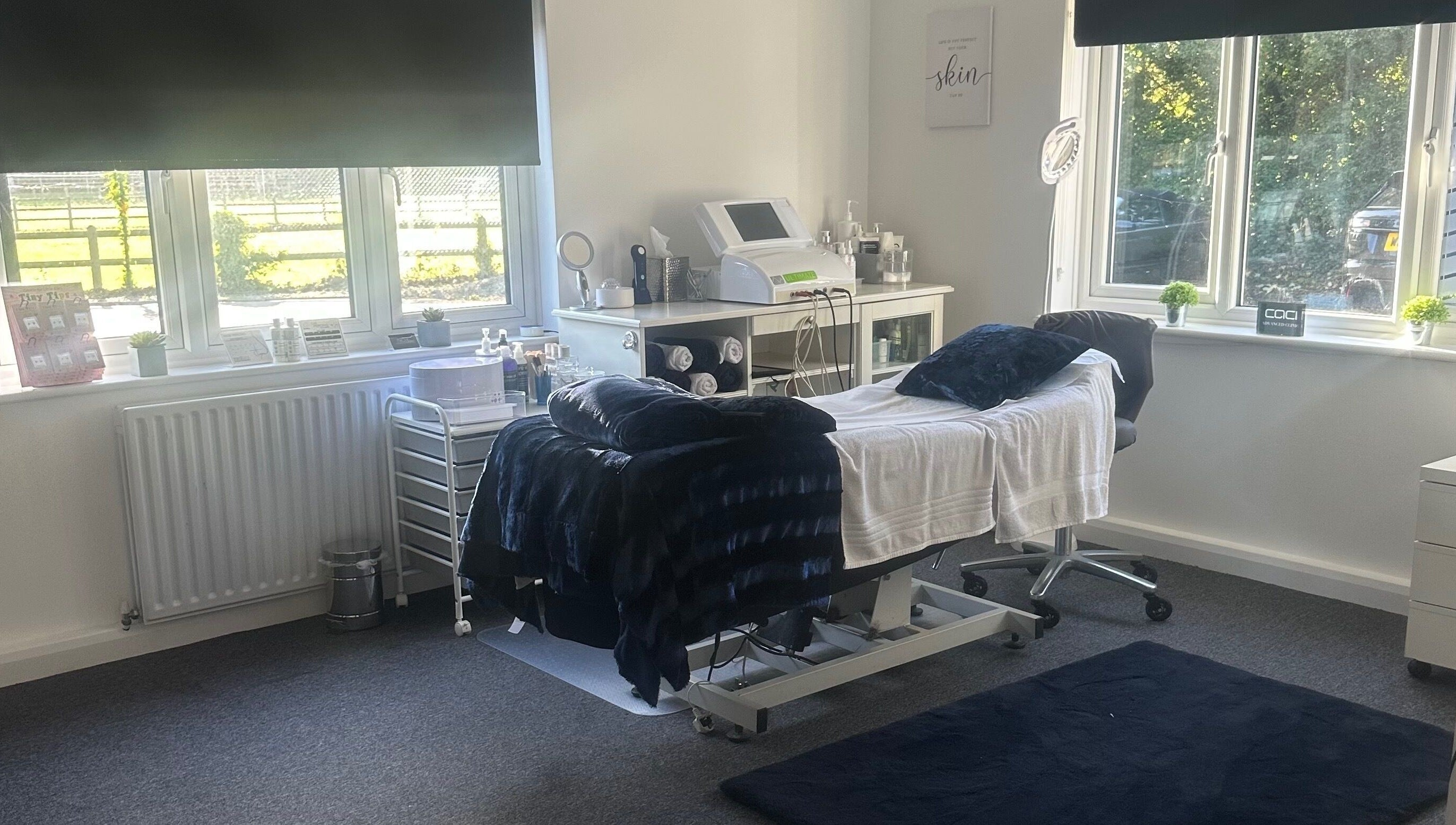 Treatment room at No.4 Aesthetics & Beauty, St Albans, England, GB, with bed, equipment, and window view.