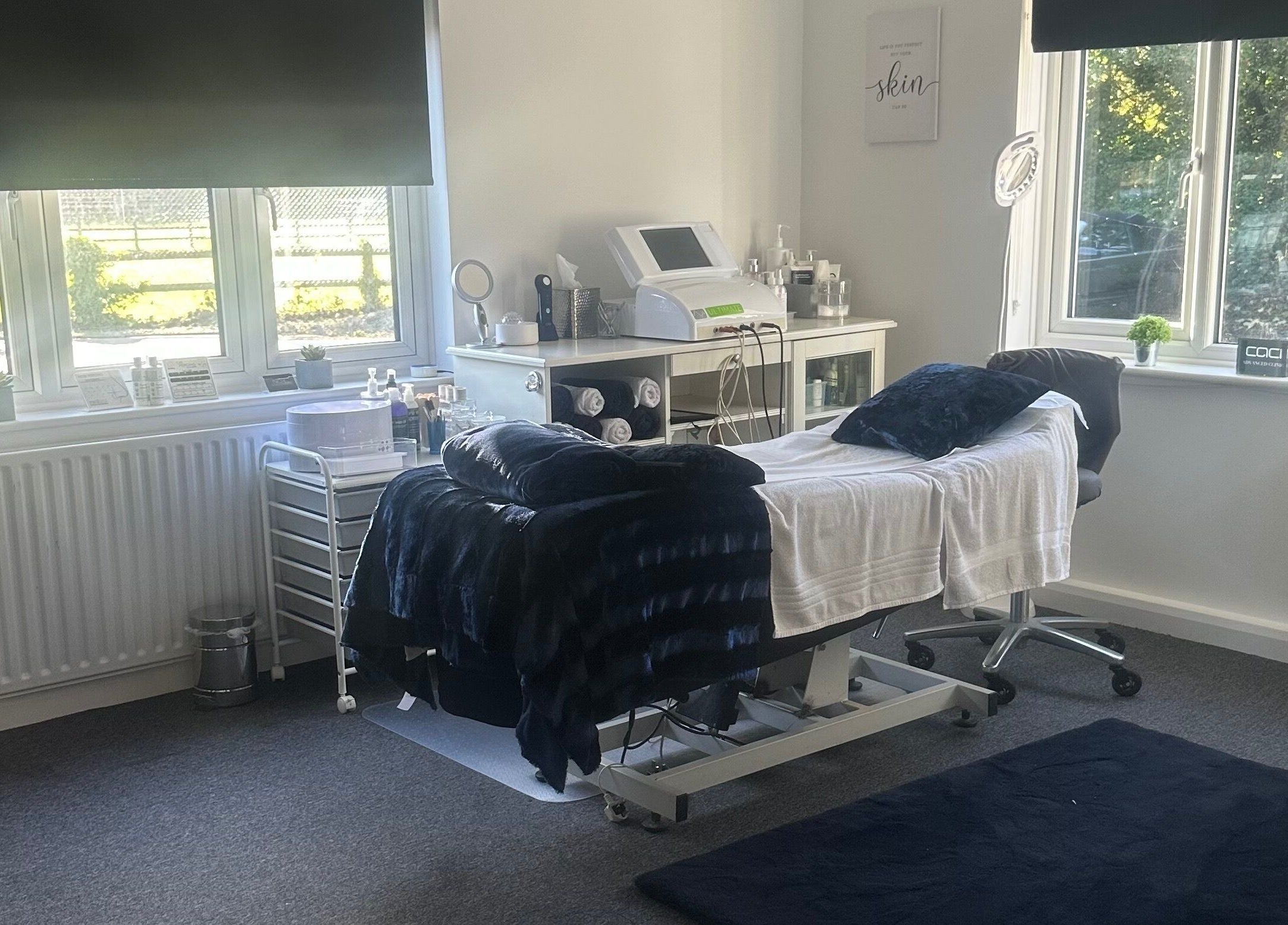 Treatment room at No.4 Aesthetics & Beauty, St Albans, England, GB, with bed, equipment, and window view.
