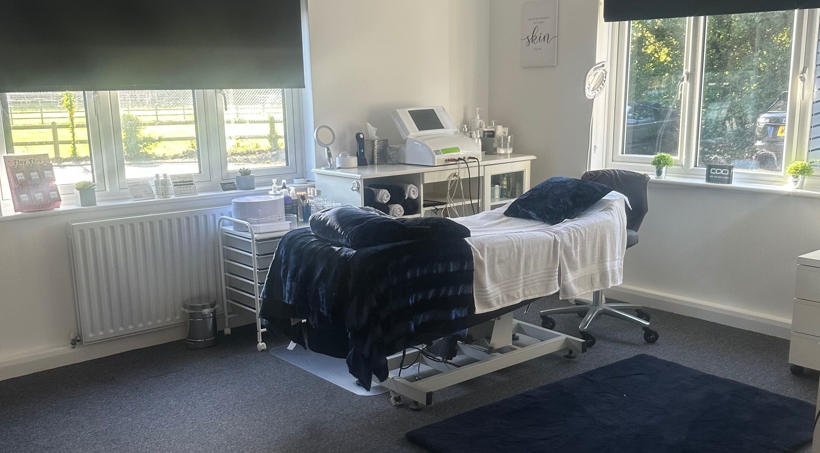 Treatment room at No.4 Aesthetics & Beauty, St Albans, England, GB, with bed, equipment, and window view.