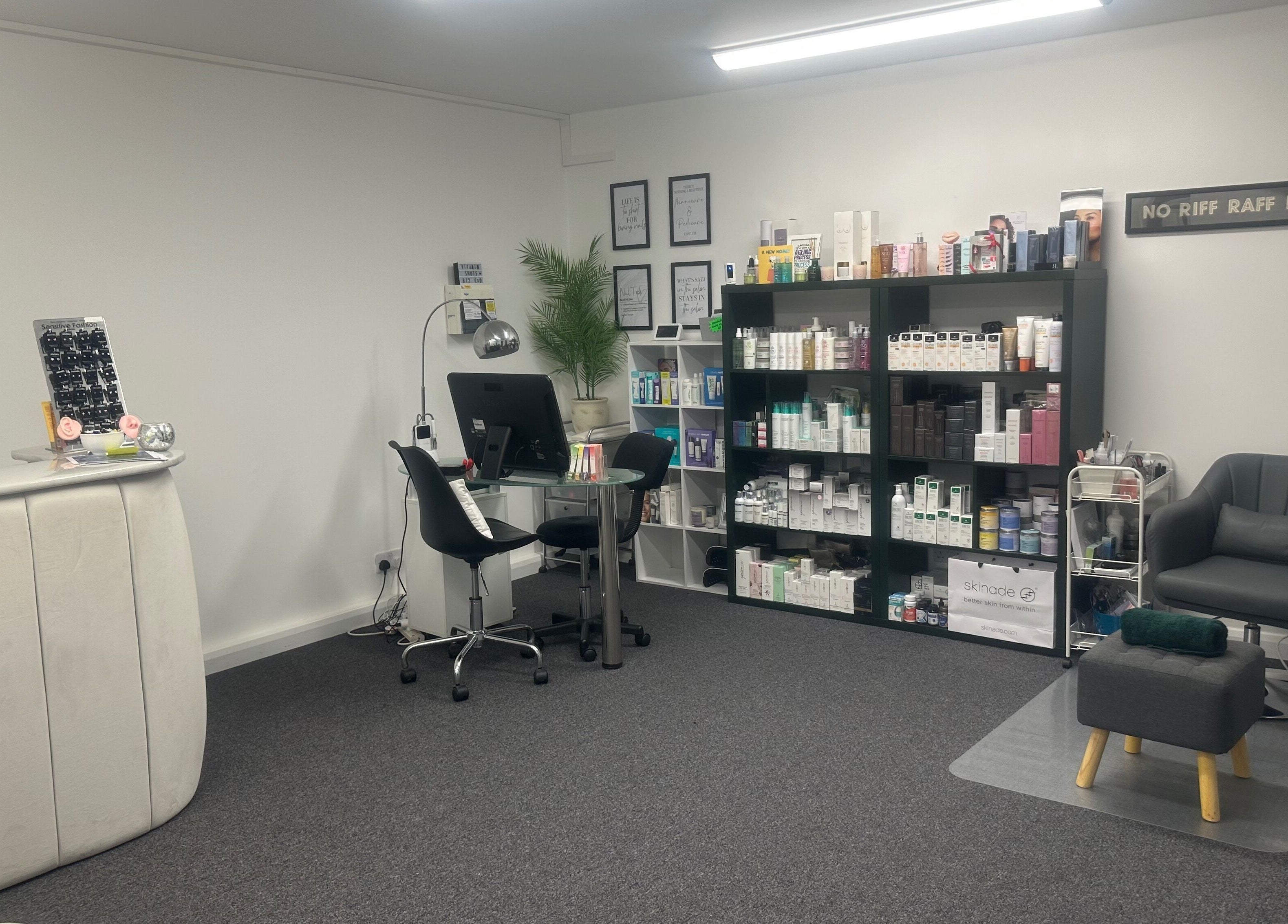 Interior of No .4 Aesthetics & Beauty in St Albans, England, GB, showcasing sleek desk, chair, and product shelves.