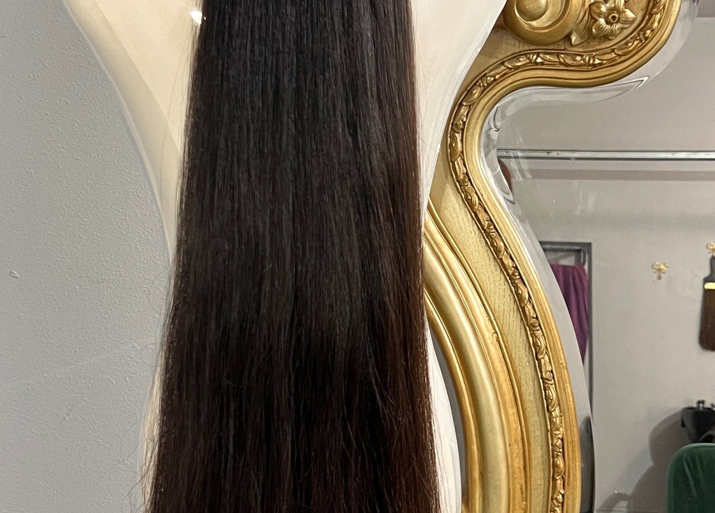 Elegant hair extensions displayed against a luxurious mirror at Hair Extensions by Denise, Mission, Texas, US.