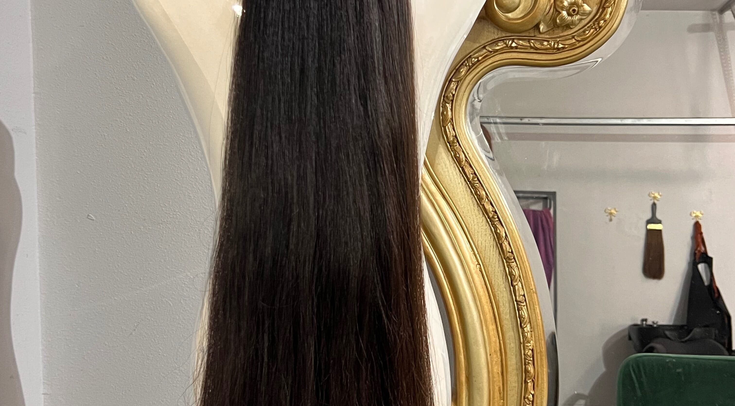 Elegant hair extensions displayed against a luxurious mirror at Hair Extensions by Denise, Mission, Texas, US.