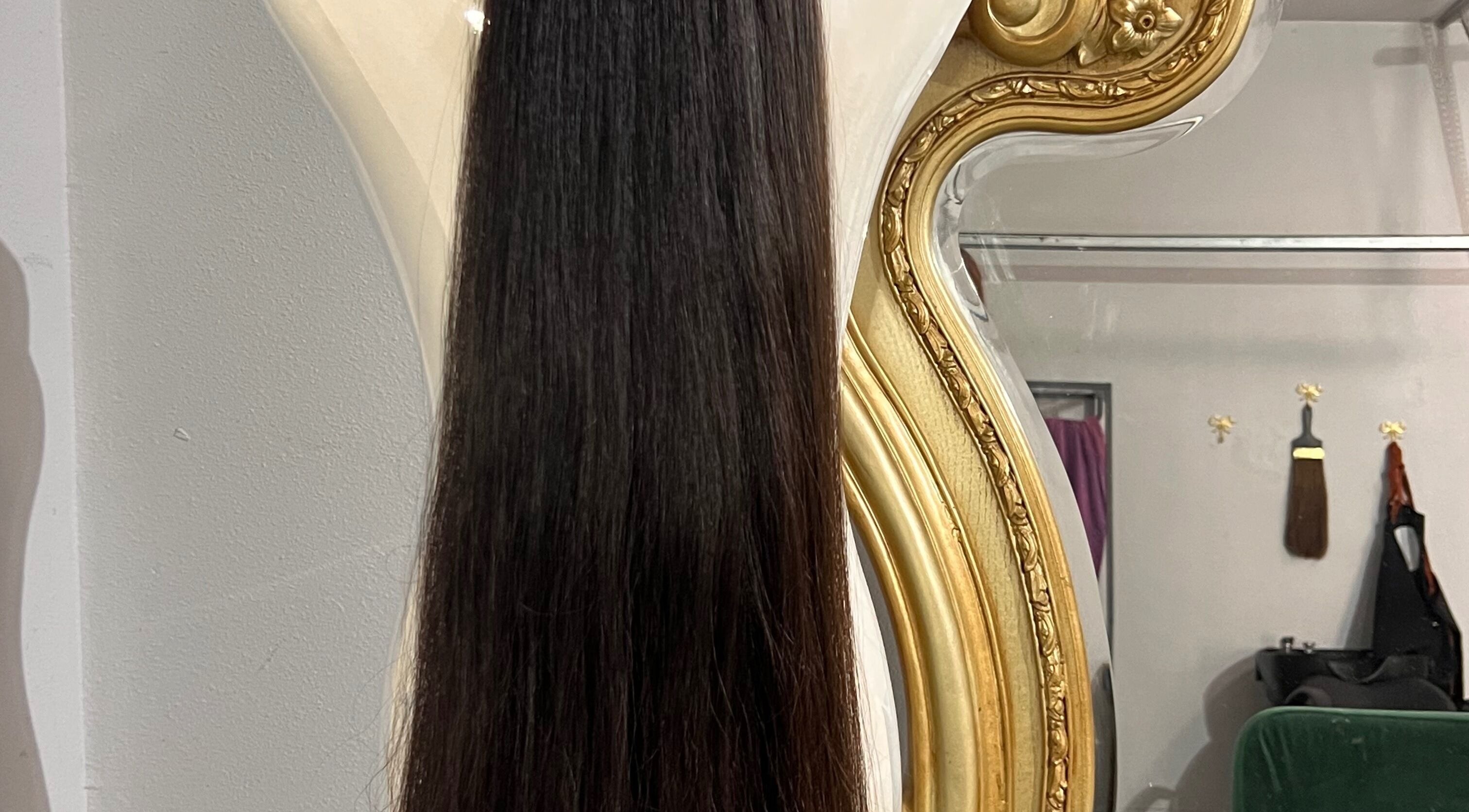 Elegant hair extensions displayed against a luxurious mirror at Hair Extensions by Denise, Mission, Texas, US.