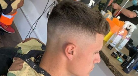 A stylish men's haircut at Hustle Barbers in Chesterfield, England, GB, showcasing a sharp fade.
