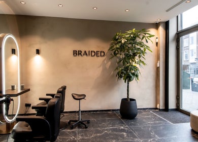 Moderne saloninrichting bij Braided in Arnhem, Gelderland, NL met luxe stoelen en natuurlijke verlichting.