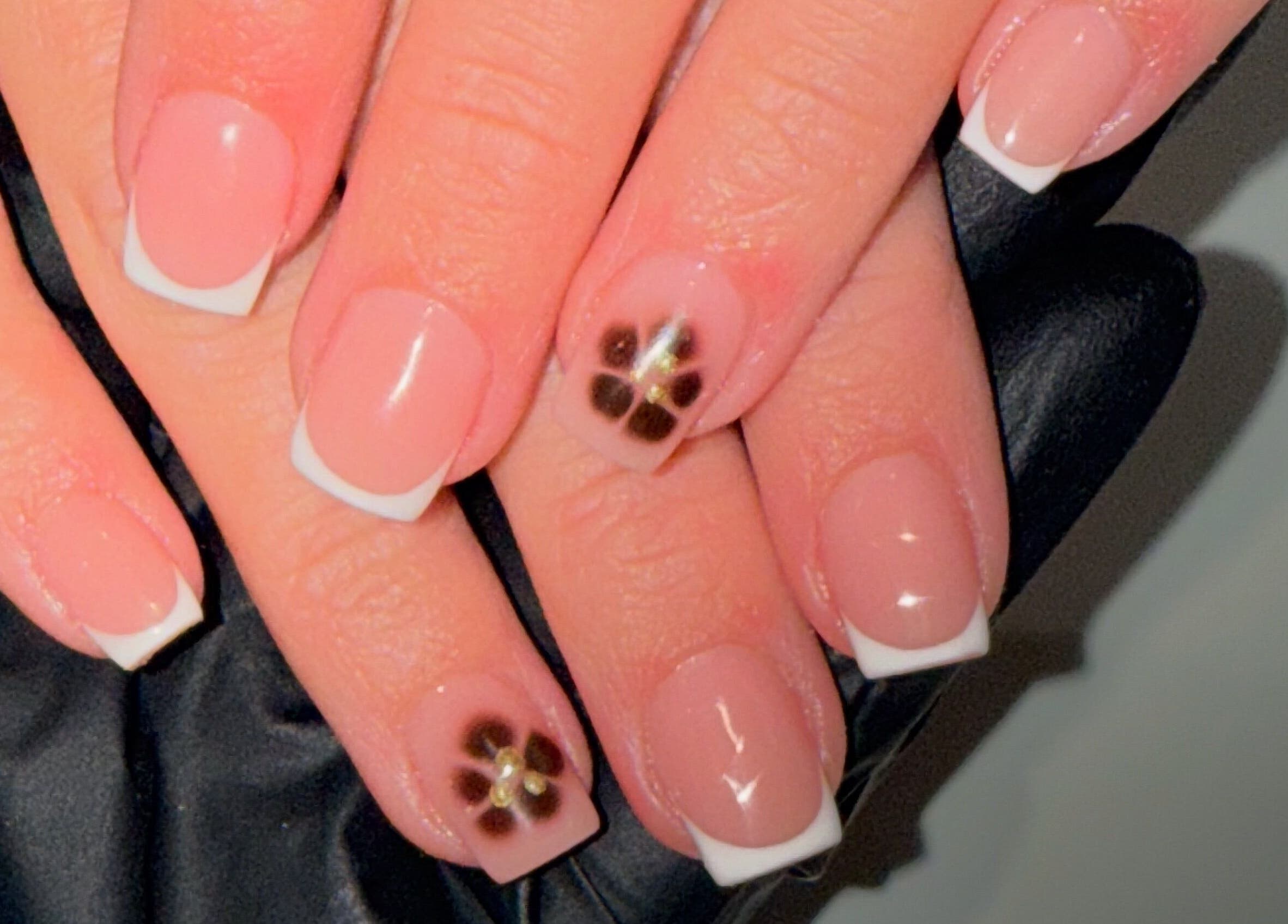 Elegant French manicure with floral accents at Lindsey Marriott Nails, Blackpool, England, GB.