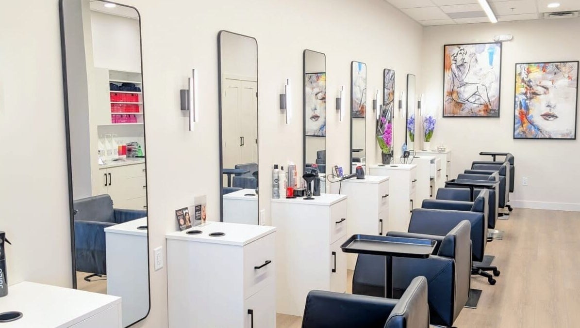 Modern styling stations at Hairworks Salon Windsor in Lasalle, Ontario, CA featuring sleek mirrors and artwork.