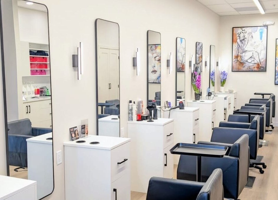 Modern styling stations at Hairworks Salon Windsor in Lasalle, Ontario, CA featuring sleek mirrors and artwork.