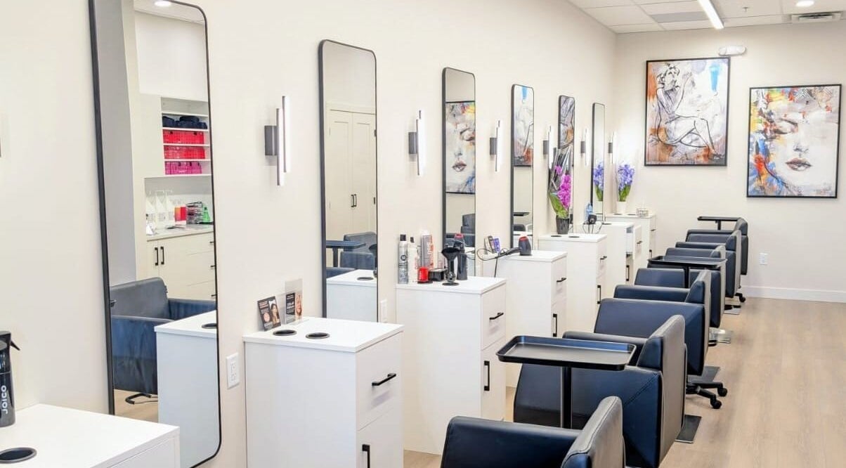 Modern styling stations at Hairworks Salon Windsor in Lasalle, Ontario, CA featuring sleek mirrors and artwork.