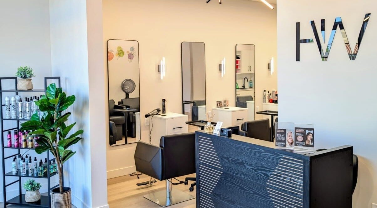 Modern interior of Hairworks Salon Windsor in Lasalle, Ontario, CA featuring stylish chairs and mirrors.