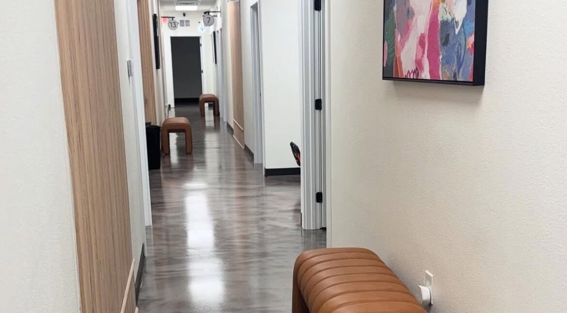 Modern hallway at Bee Lashed by Barb, Rockledge, Florida, US with stylish decor and seating.