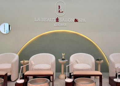 Elegant seating area at La Beaute Salon and Spa in Al Khobar, Eastern Province, SA, showcasing plush white chairs.