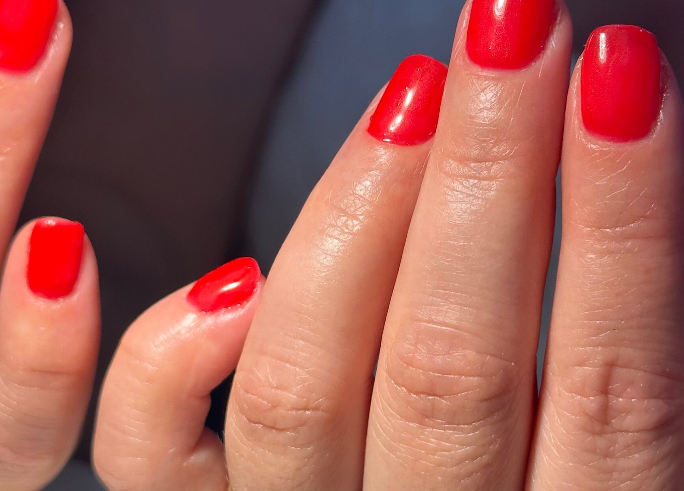 Vibrant red manicure at Biriznailbar, Bournemouth, England, GB, showcasing polished elegance.
