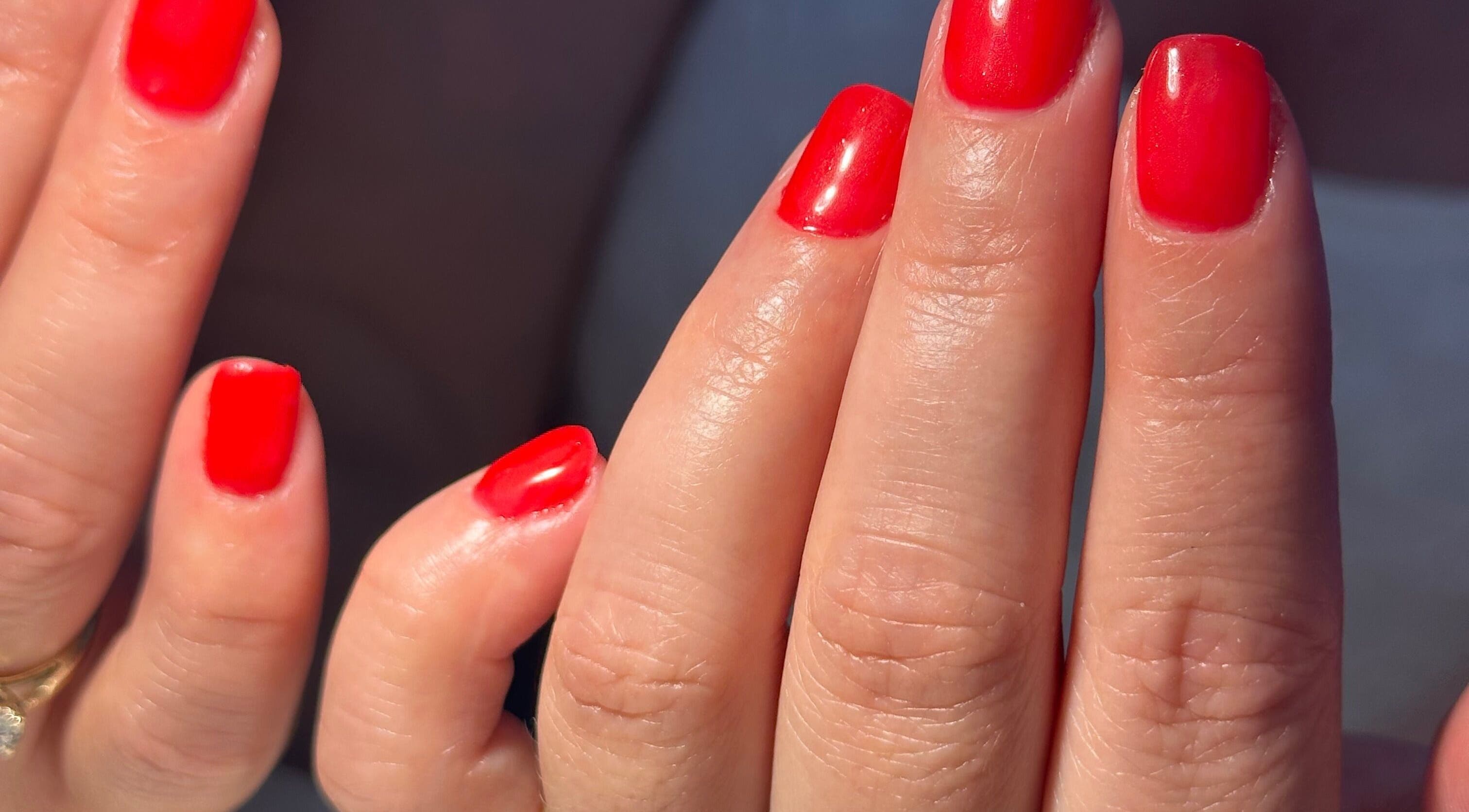 Vibrant red manicure at Biriznailbar, Bournemouth, England, GB, showcasing polished elegance.