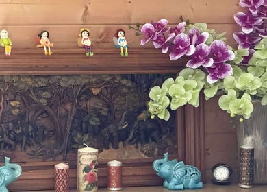 Orchid arrangement and figurines at Oak Barn Thai Massage in Lingfield, Newchapel, England, GB.