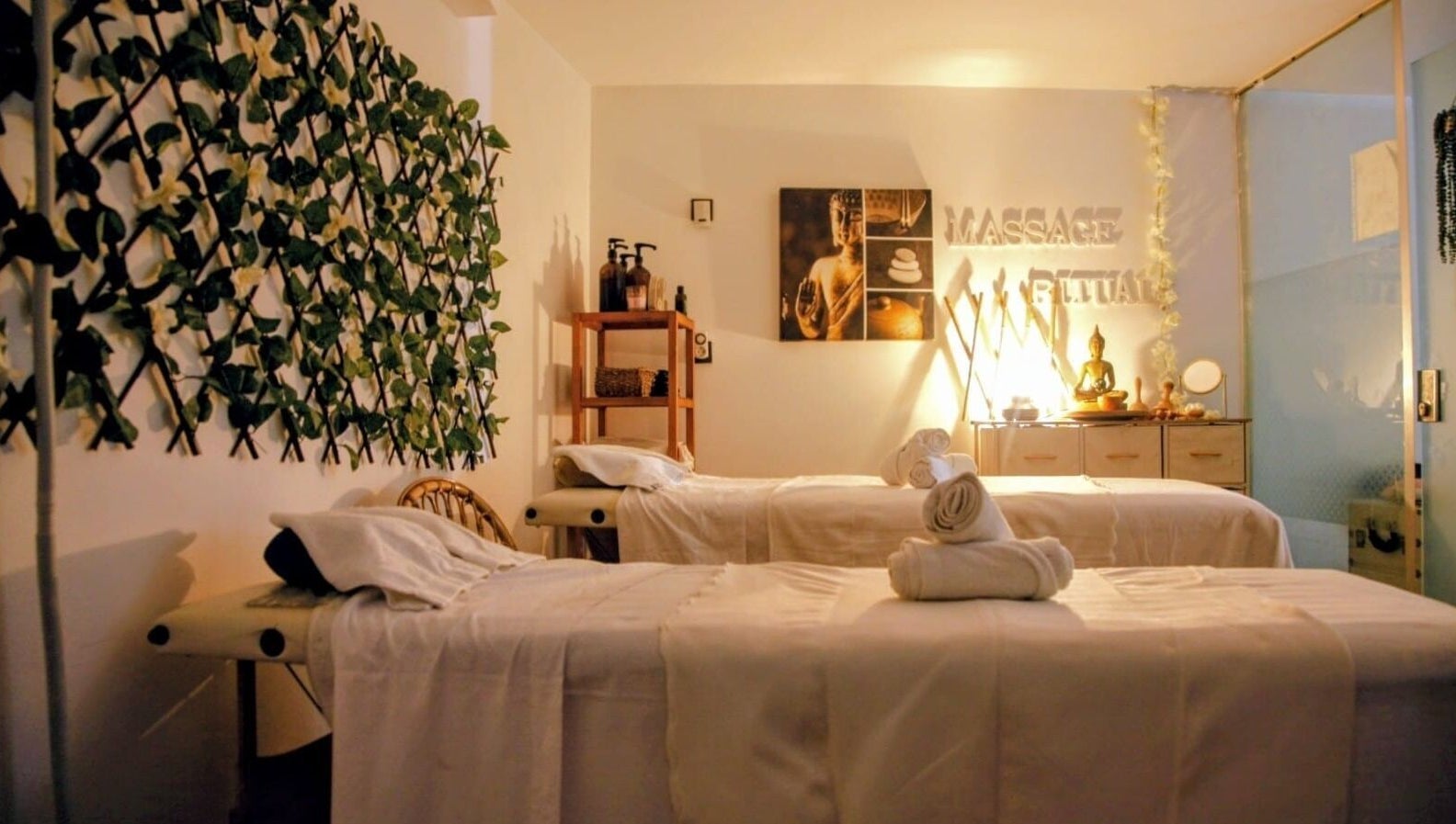 Sala de masajes en Massage Ritual Bcn, Barcelona, Catalunya, ES, con camas dobles y decoración natural.