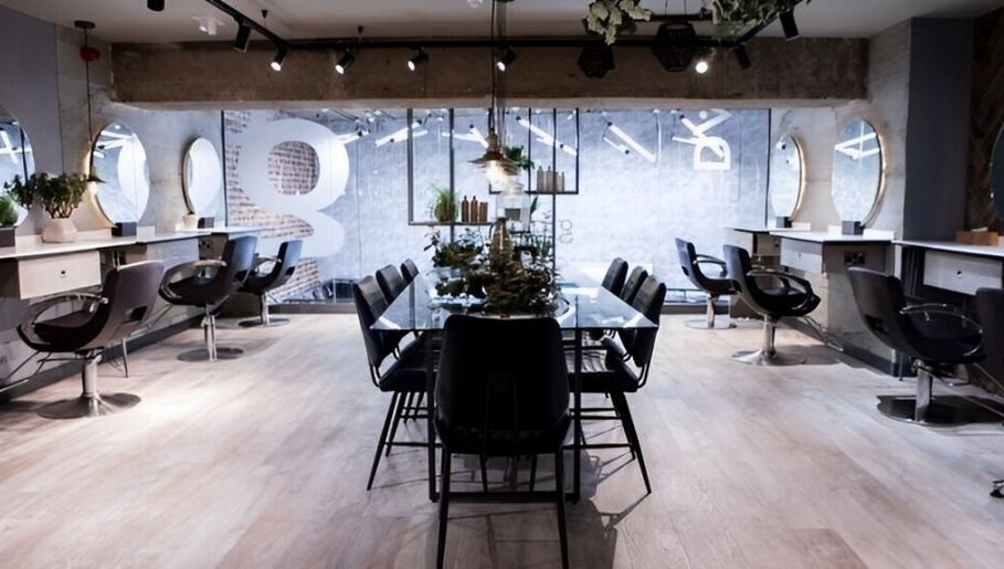 Modern salon interior at Gina Conway Beauty, London, England, GB, featuring sleek chairs and minimalist decor.