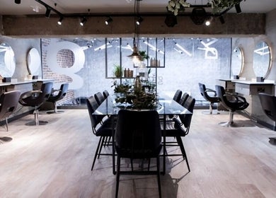 Modern salon interior at Gina Conway Beauty, London, England, GB, featuring sleek chairs and minimalist decor.