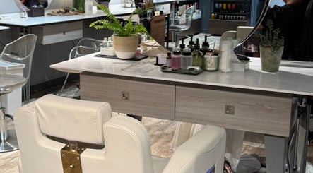 Elegant styling station at Gina Conway Beauty, London, England, GB. Features a plush chair and chic decor.