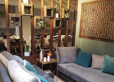 Cozy lounge area at Gina Conway Beauty, London, England, GB, showcasing stylish decor and comfy seating.