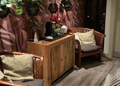 Cozy seating area with plants at Gina Conway Beauty, London, England, GB.
