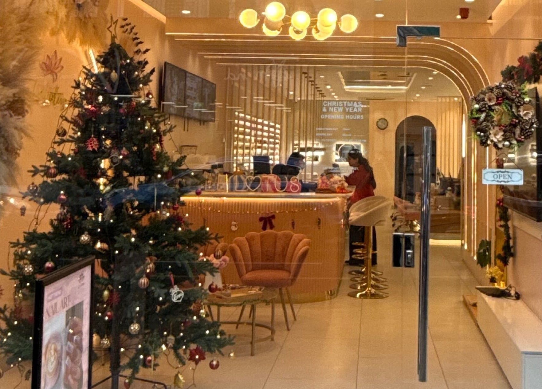 Holiday-decorated entrance of 107 Putney high street SW15 1SS in London, England, GB, showcasing a festive wellness interior.
