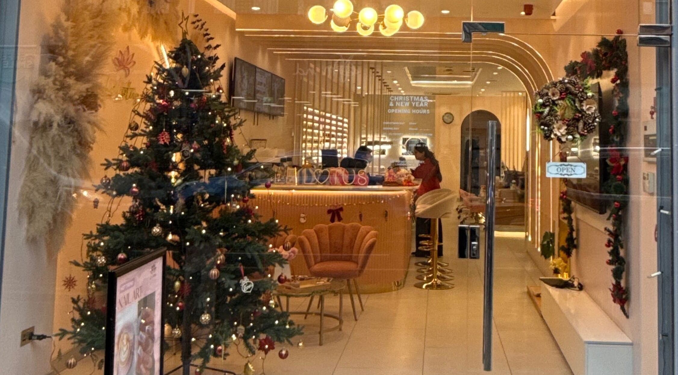 Holiday-decorated entrance of 107 Putney high street SW15 1SS in London, England, GB, showcasing a festive wellness interior.