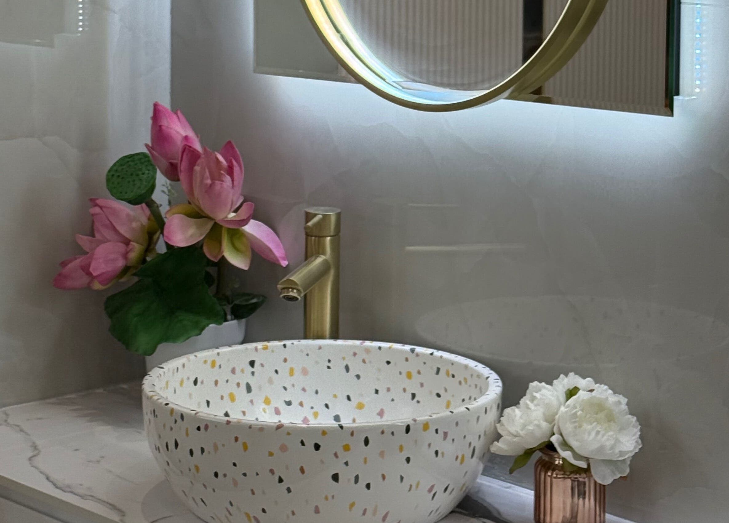 Elegant floral-adorned sink at 107 Putney high street SW15 1SS, London, England, GB enhancing venue's ambiance.